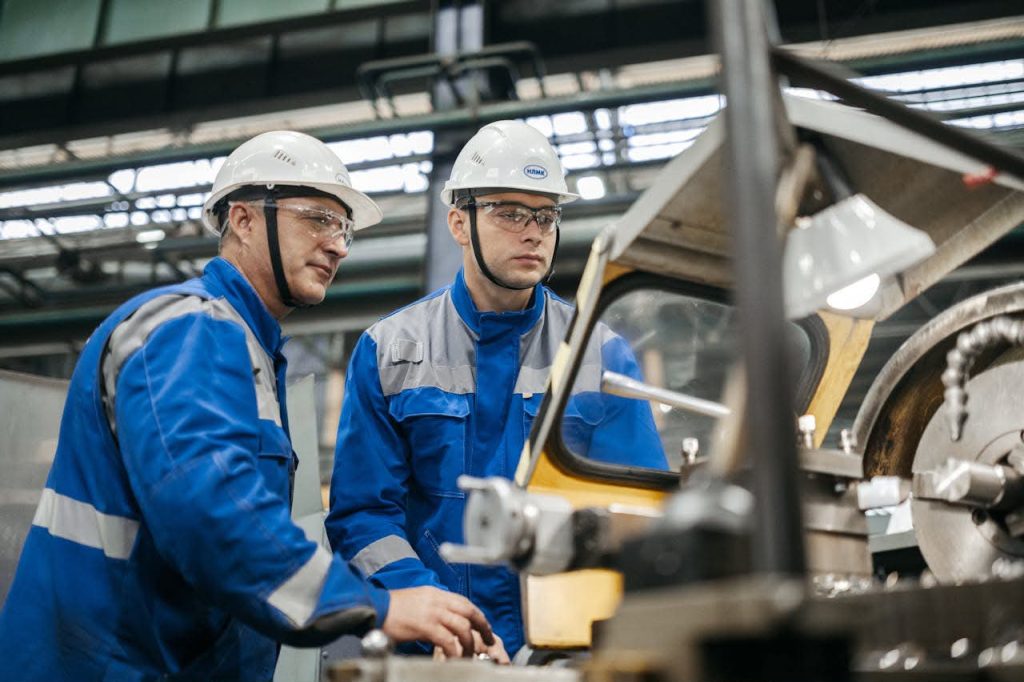 Professional industrial automation consultant discussing digital transformation and workflow optimization with a manufacturing plant manager.